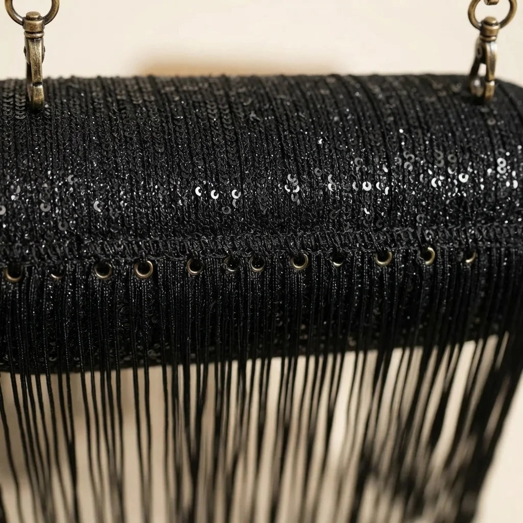Close-up of fringe stitching and texture on black fringe evening bag