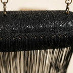 Close-up of fringe stitching and texture on black fringe evening bag