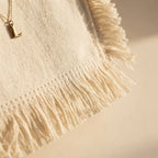 Close-up of fringe stitching and texture on Cream oversized beach bag fringe