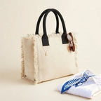Cream oversized beach bag fringe, three-quarter angle showing side depth