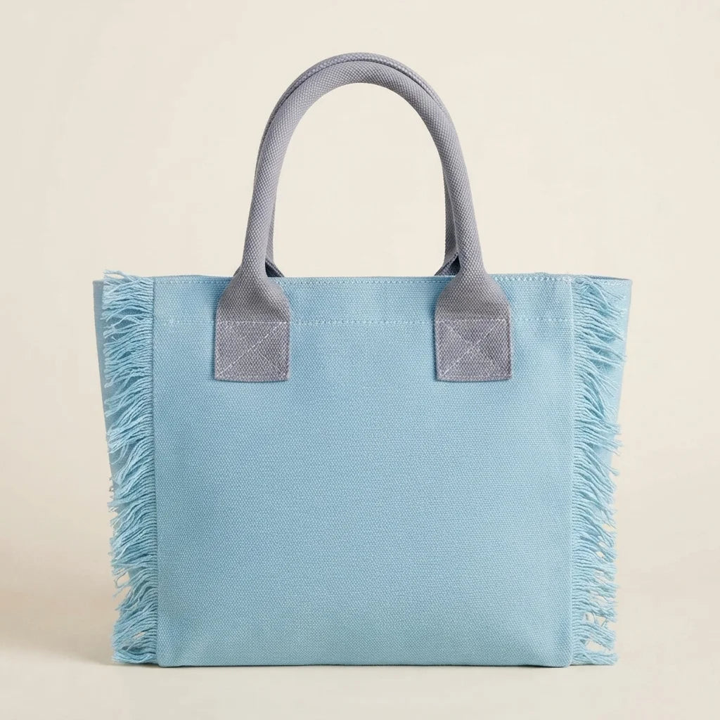 Back panel of Light Blue oversized beach bag fringe with strap attachments