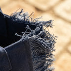 Close-up of fringe stitching and texture on Navy beach bag