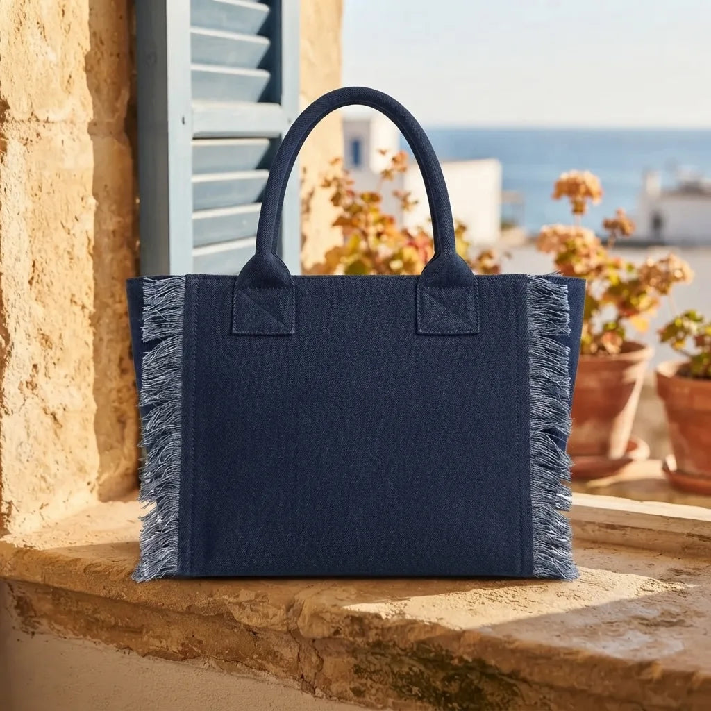Navy beach bag styled in a warm Mediterranean setting