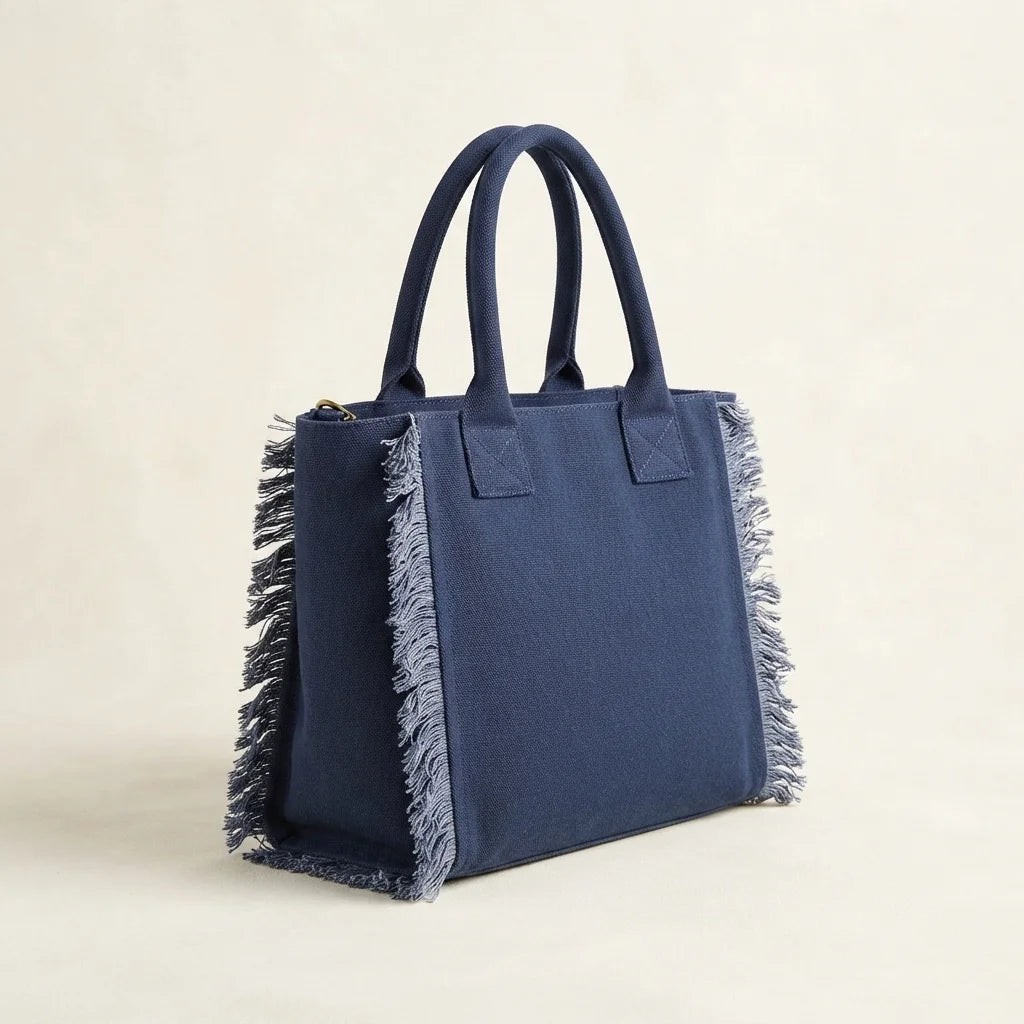 Navy oversized beach bag fringe, three-quarter angle showing side depth