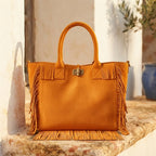 Orange beach bag styled in a warm Mediterranean setting