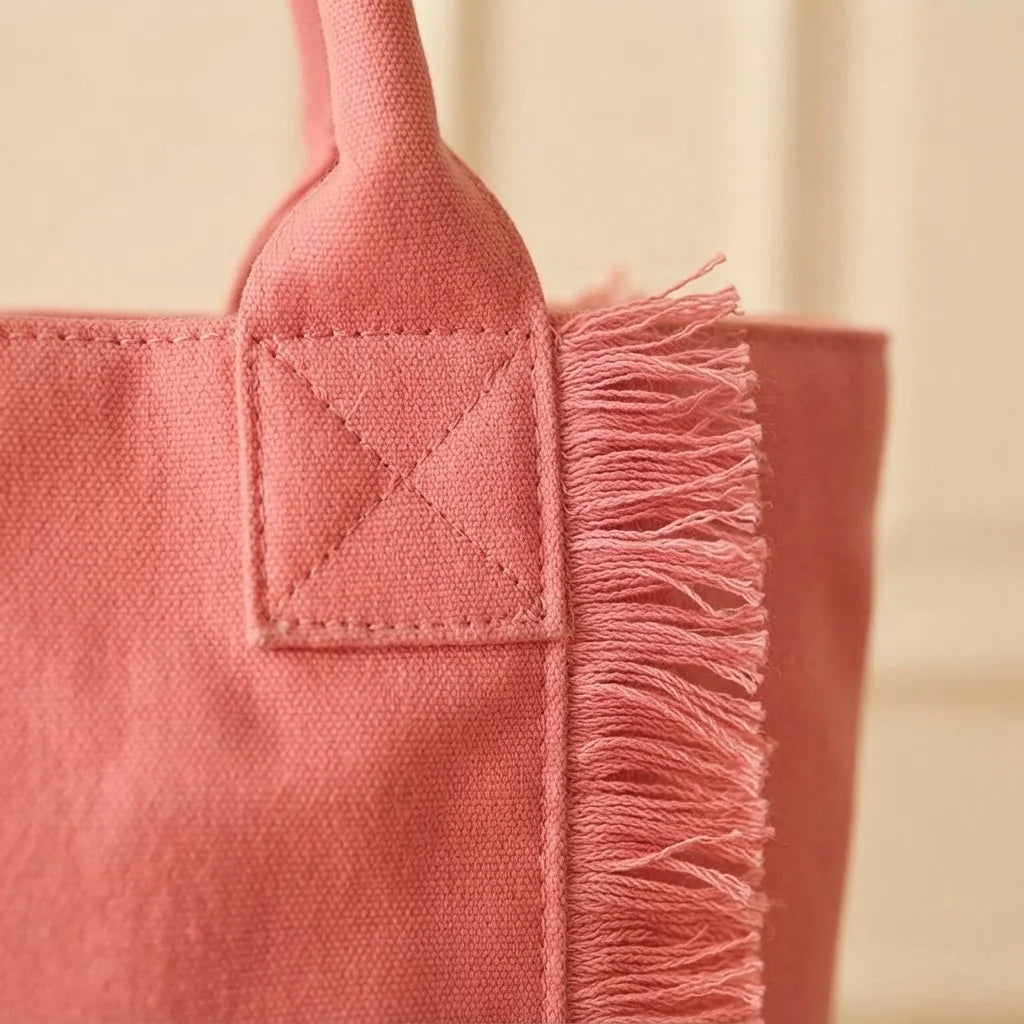 Close-up of fringe stitching and texture on Pink oversized beach bag fringe