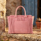 Pink beach bag styled in a warm Mediterranean setting