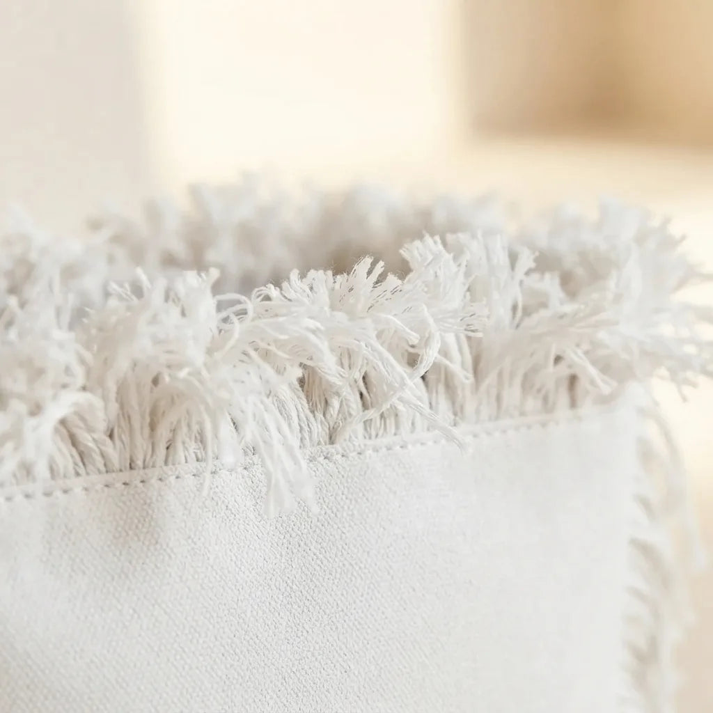 Close-up of fringe stitching and texture on White beach bag