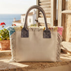 White beach bag styled in a warm Mediterranean setting