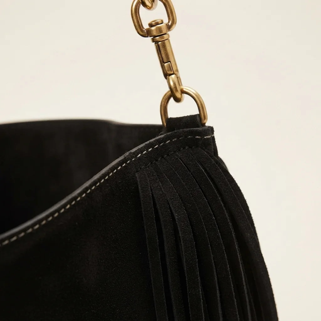 Close-up of fringe stitching and texture on Black oversized fringe bag