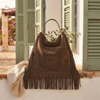 Coffee oversized fringe bag styled in a warm Mediterranean setting