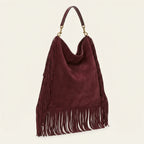 Maroon oversized fringe bag, three-quarter angle showing side depth