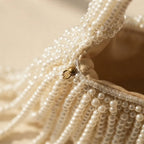 Close-up of fringe stitching and texture on White pearl fringe bag