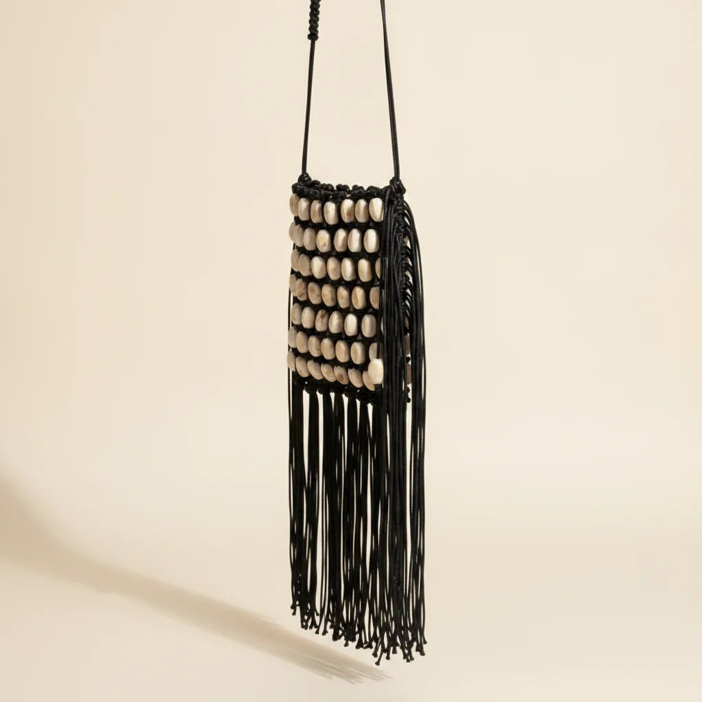 Black pearl fringe clutch bag, three-quarter angle showing side depth