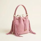 Pink pink bucket bag with fringe, three-quarter angle showing side depth