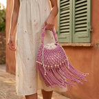 Woman wearing Pink pink bucket bag with fringe with swaying fringe