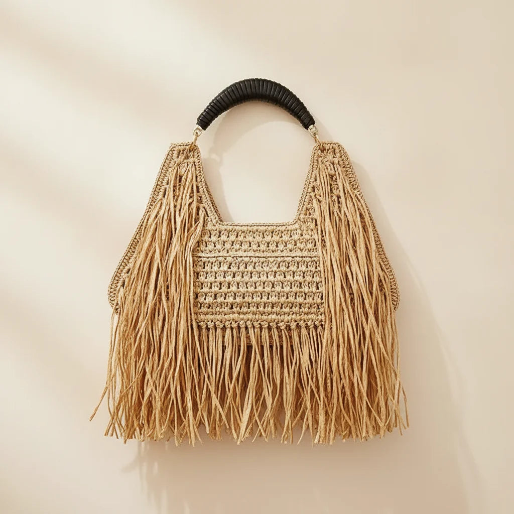 Back panel of Natural raffia fringe crescent bag with strap attachments