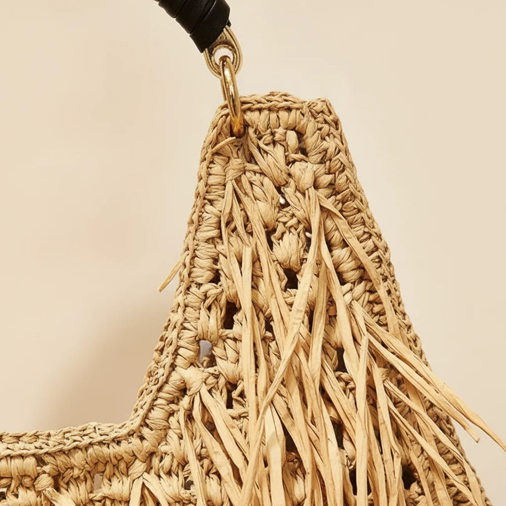 Close-up of fringe stitching and texture on Natural raffia fringe crescent bag