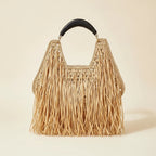 Natural raffia fringe crescent bag, front view