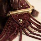 Close-up of fringe stitching and texture on Burgundy red fringe clutch bag
