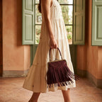 Woman wearing Burgundy red fringe clutch bag with swaying fringe
