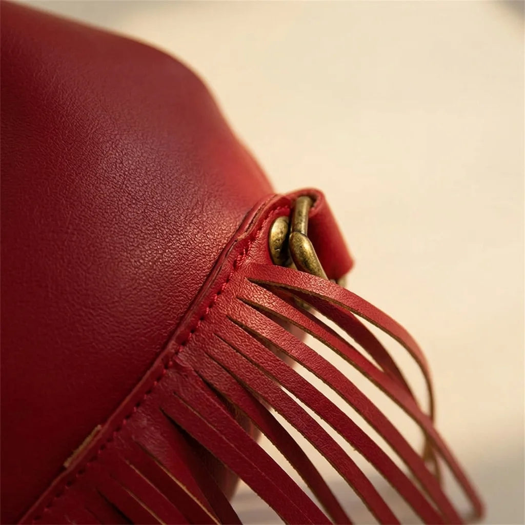 Close-up of fringe stitching and texture on Red red leather fringe bag