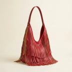 Red red leather fringe bag, three-quarter angle showing side depth