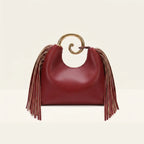 Back panel of Burgundy red leather fringe hobo bag with strap attachments