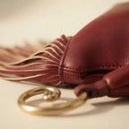 Close-up of fringe stitching and texture on Burgundy red leather fringe hobo bag
