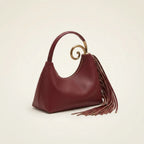 Burgundy red leather fringe hobo bag, three-quarter angle showing side depth