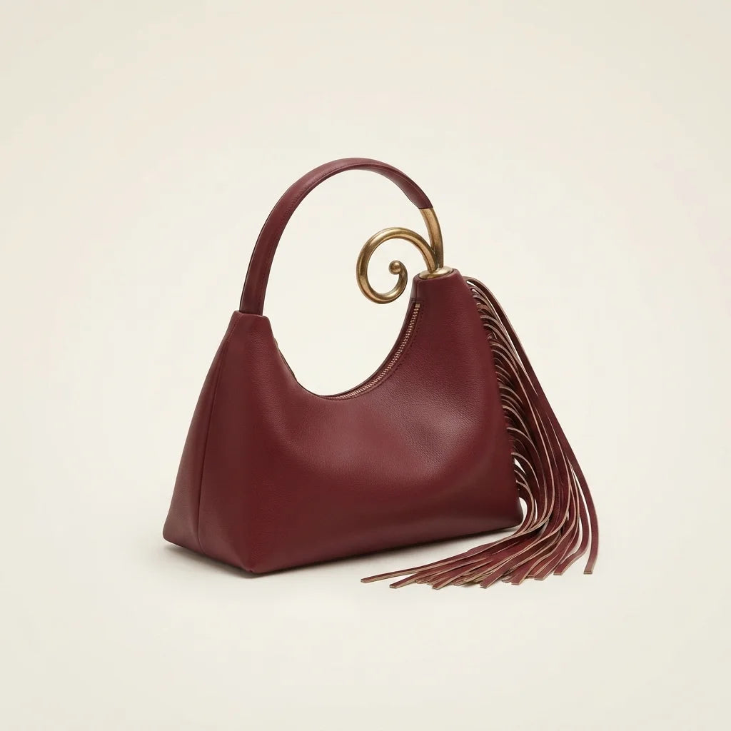 Burgundy red leather fringe hobo bag, three-quarter angle showing side depth