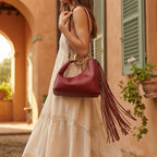 Woman wearing Burgundy red leather fringe hobo bag with swaying fringe