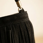 Close-up of fringe stitching and texture on Black slouchy fringe bag