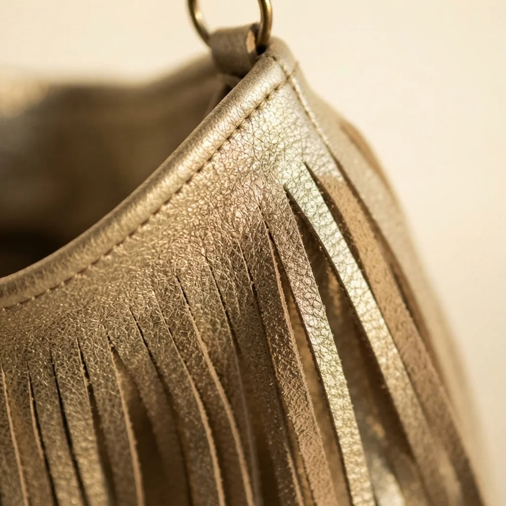 Close-up of fringe stitching and texture on Gold slouchy fringe bag