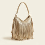 Gold slouchy fringe bag, three-quarter angle showing side depth