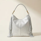 Back panel of Silver slouchy fringe bag with strap attachments