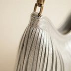 Close-up of fringe stitching and texture on Silver slouchy fringe bag