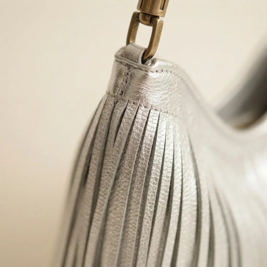 Close-up of fringe stitching and texture on Silver slouchy fringe bag