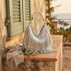 Silver slouchy fringe bag styled in a warm Mediterranean setting