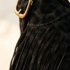 Close-up of fringe stitching and texture on Black small black fringe bag