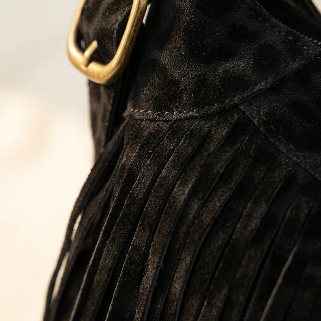 Close-up of fringe stitching and texture on Black small black fringe bag
