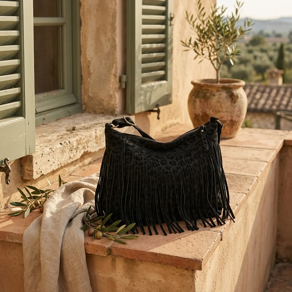 Black small black fringe bag styled in a warm Mediterranean setting