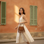 Woman wearing Brown small fringe bag with swaying fringe