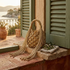 Gold small fringe bucket bag styled in a warm Mediterranean setting
