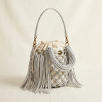 Silver small fringe bucket bag, three-quarter angle showing side depth
