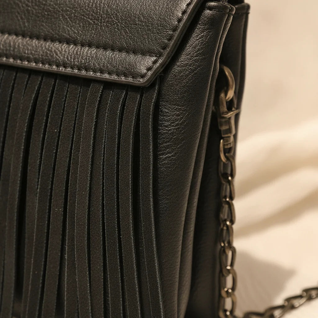 Close-up of fringe stitching and texture on Black small fringe crossbody bag