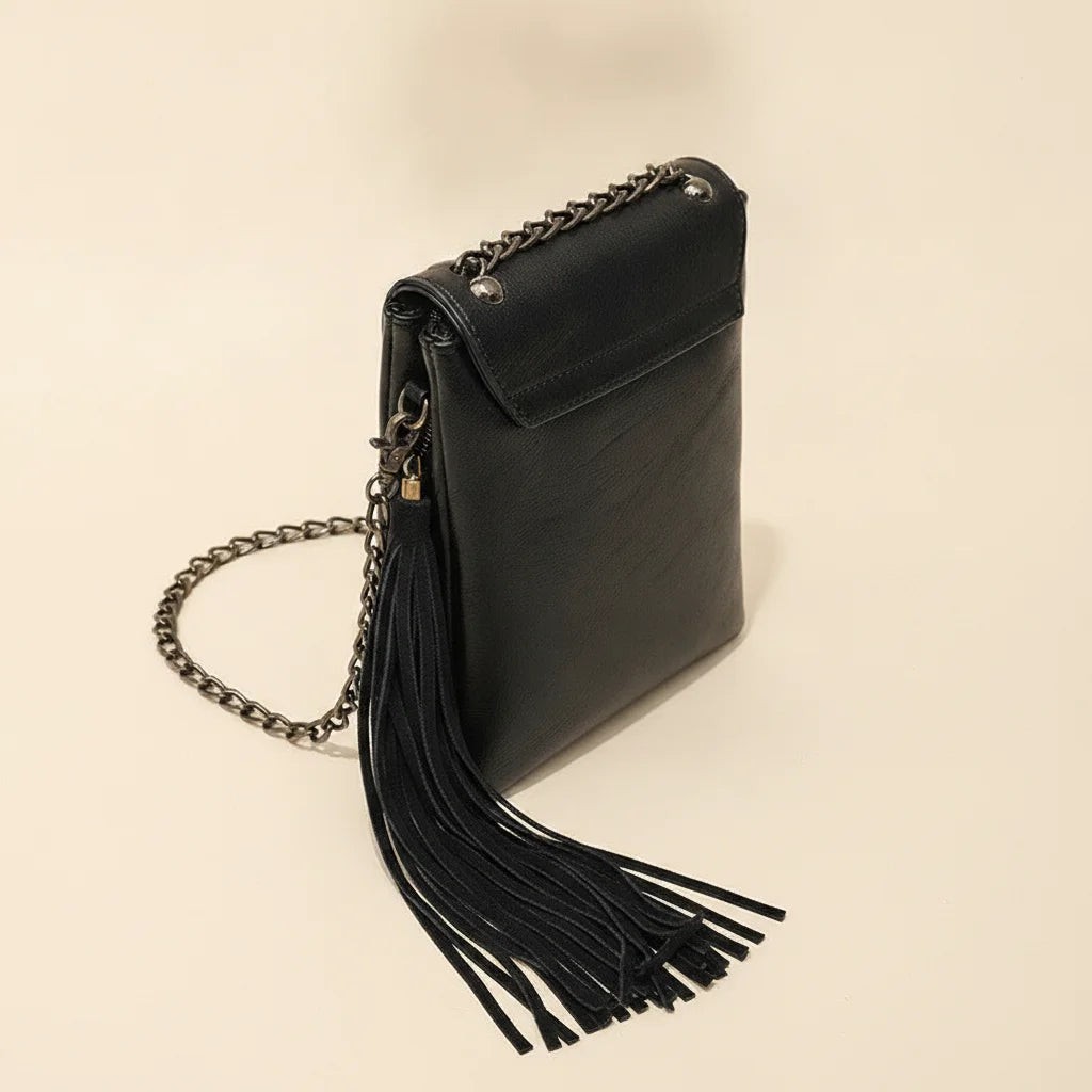 Black small fringe crossbody bag, three-quarter angle showing side depth