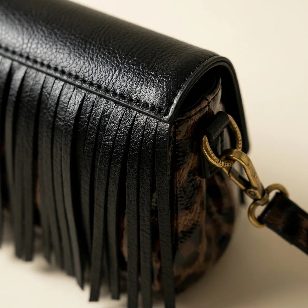 Close-up of fringe stitching and texture on Black small fringe leather crossbody bag