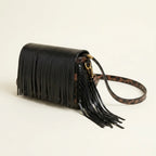 Black small fringe leather crossbody bag, three-quarter angle showing side depth
