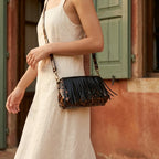 Woman wearing Black small fringe leather crossbody bag with swaying fringe